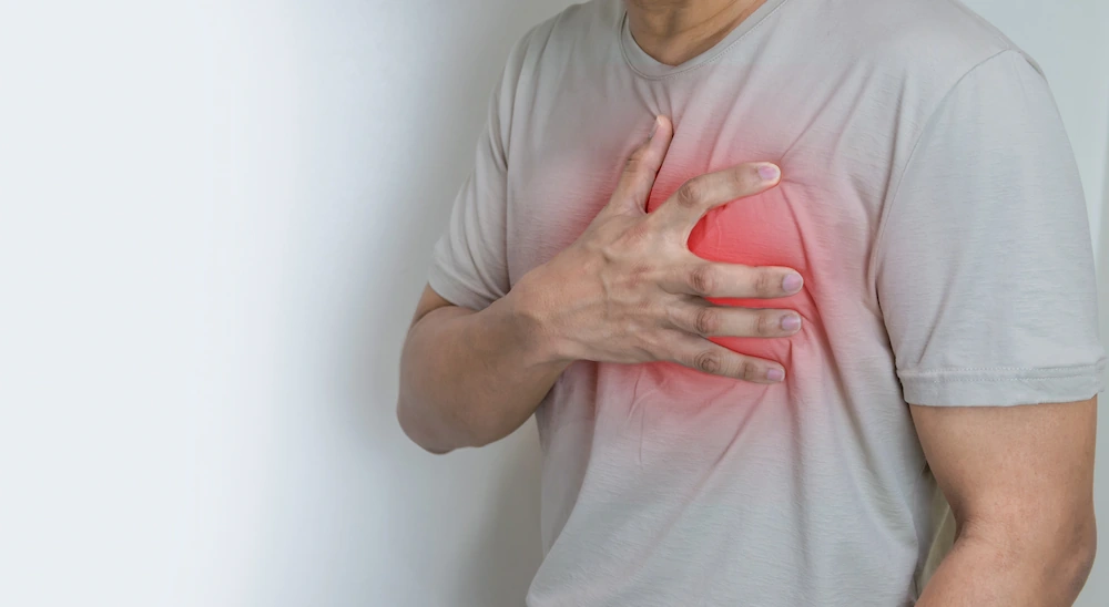 Hands holding chest with symptom heartburn