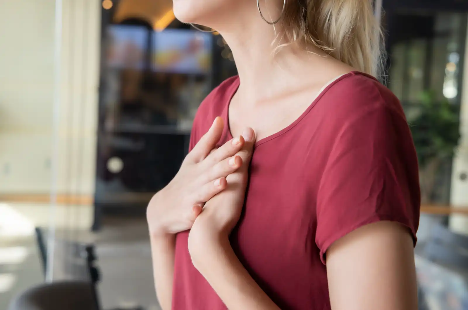woman experiencing gerd and holding her chest