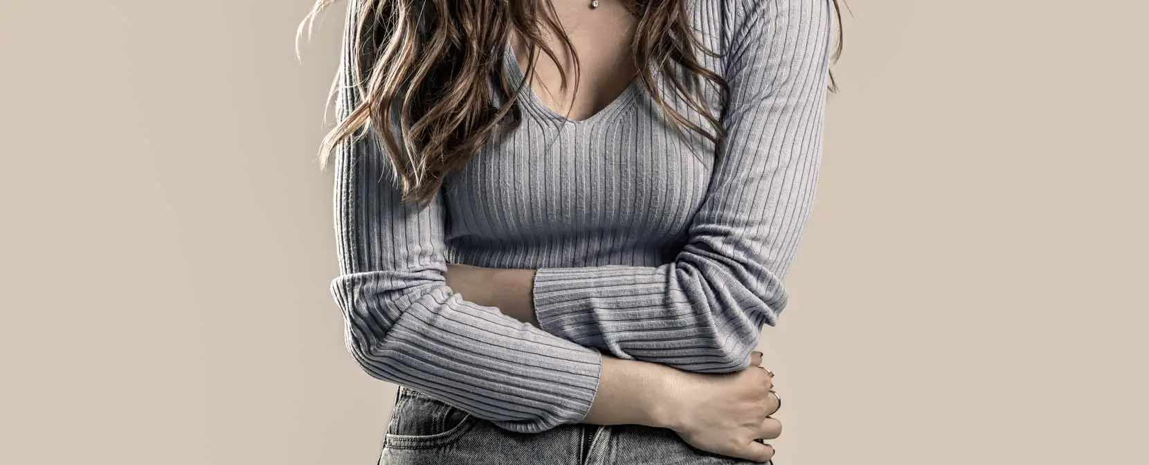Woman holding her stomach in discomfort from gastroparesis symptoms