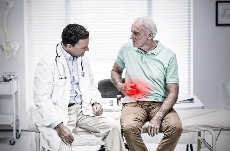man talking to doctor about stomach pain